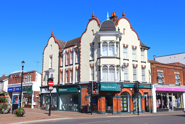 Photo of airplane flying in blue sky over Horley